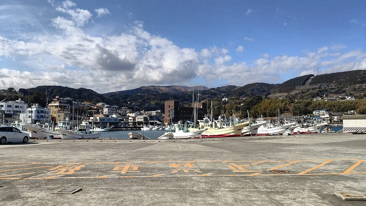 Fishing boats and waterfront buildings in Inatori harbor